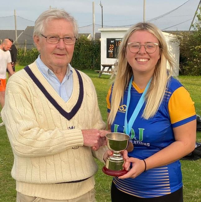 Katie Griffiths receives the trophy from Nick Evans